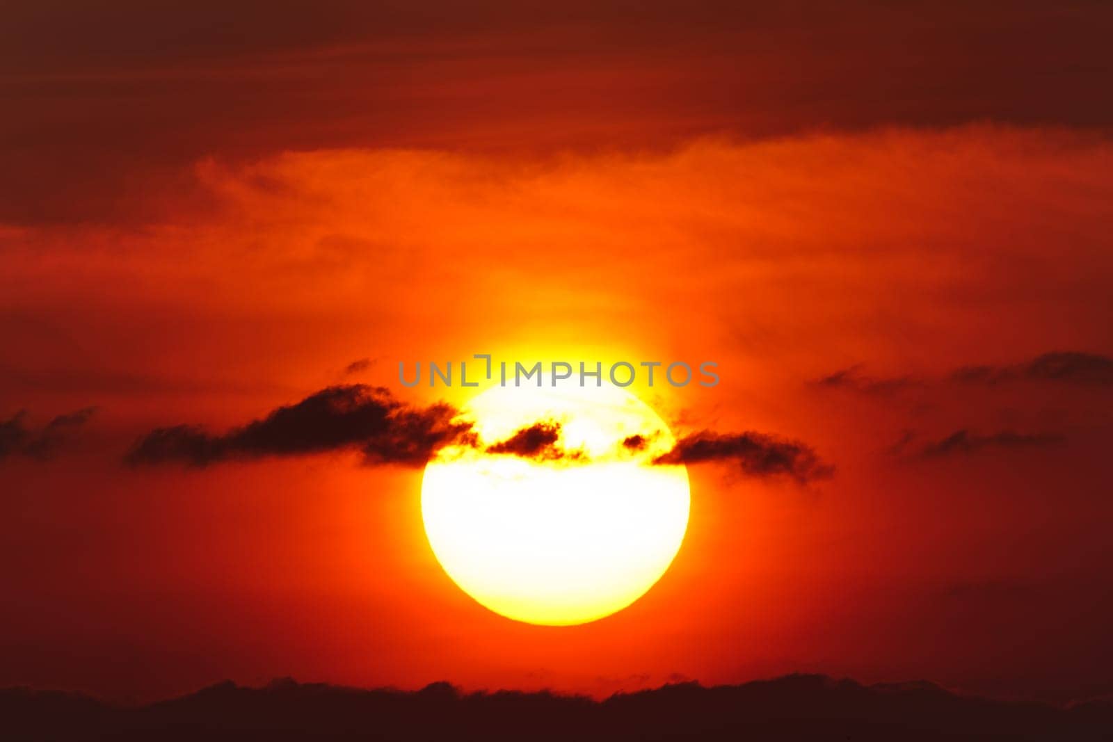 a beautiful sunrise through the clouds black