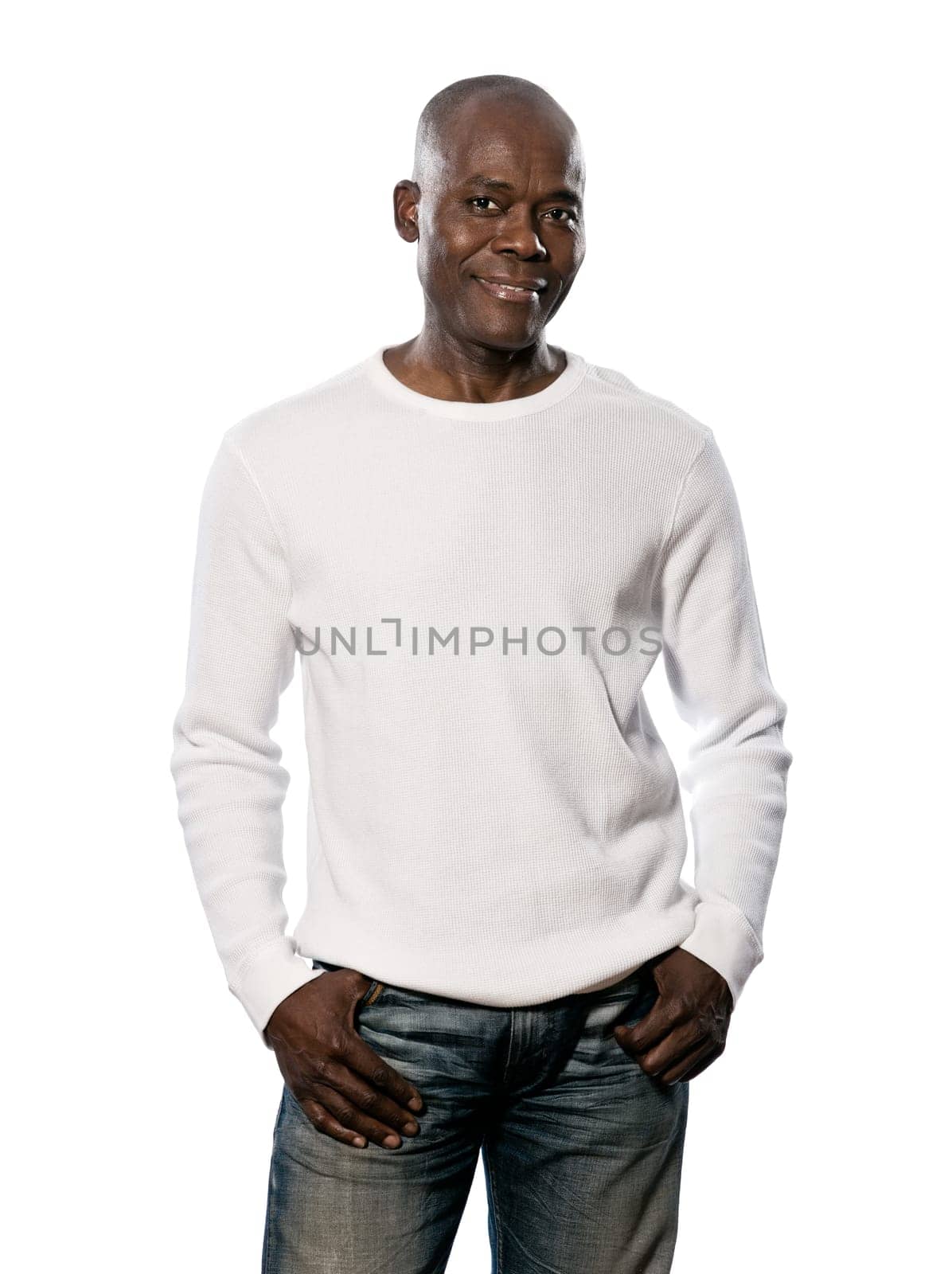 Portrait of a happy casual afro American man standing with hands in pocket in studio on white isolated background