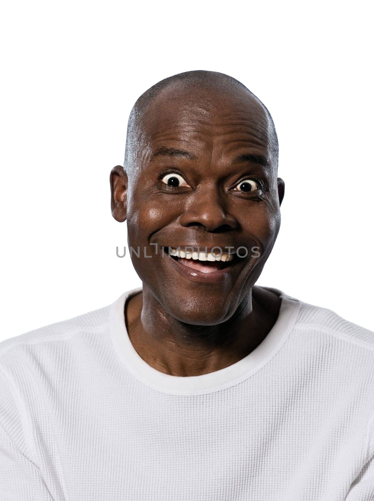 Portrait of an expressive Afro American man smiling with eyes wide open in studio on white isolated background