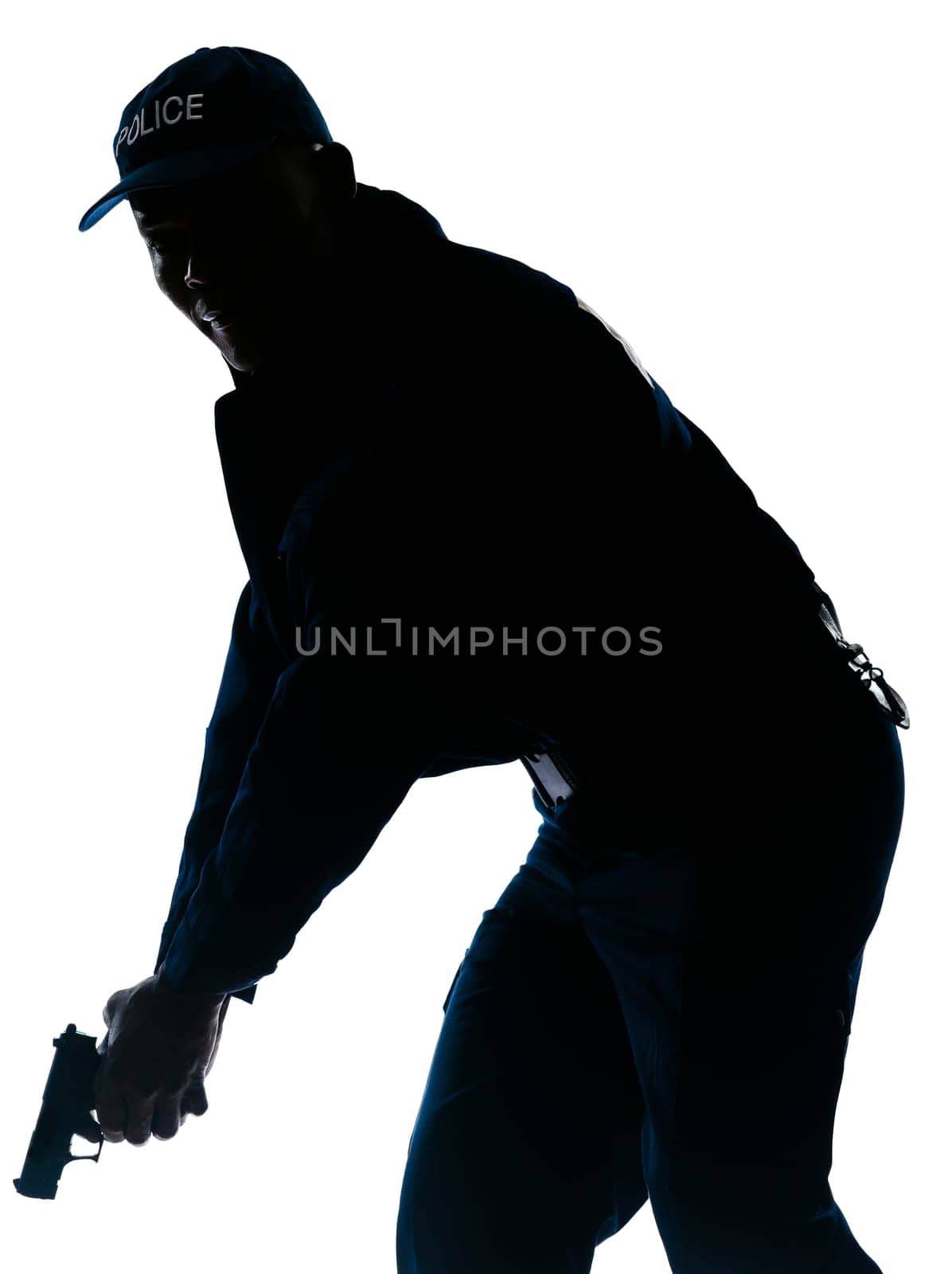 Silhouetted image of afro American policeman holding handgun in studio on white isolated background