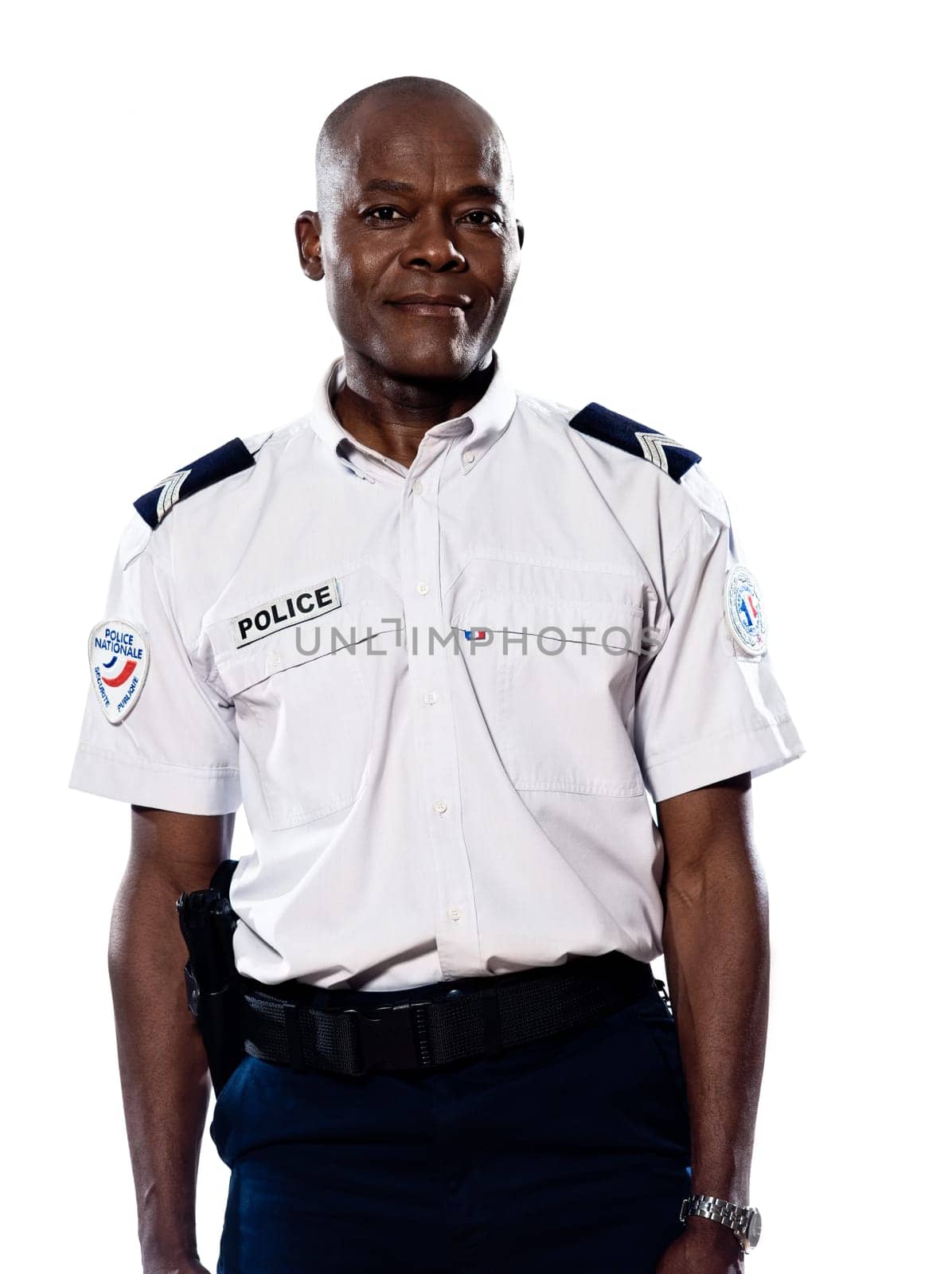 Portrait of an afro American mature policeman standing in studio on white isolated background