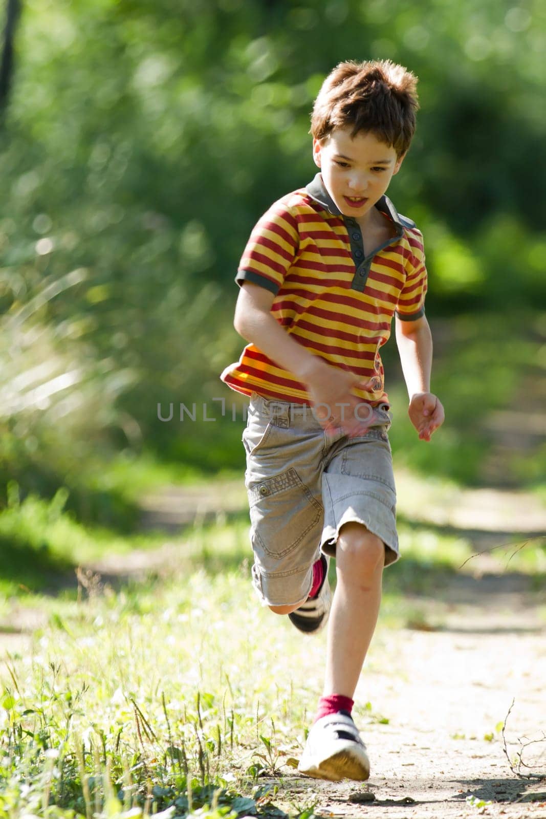 A young boy running in the nature