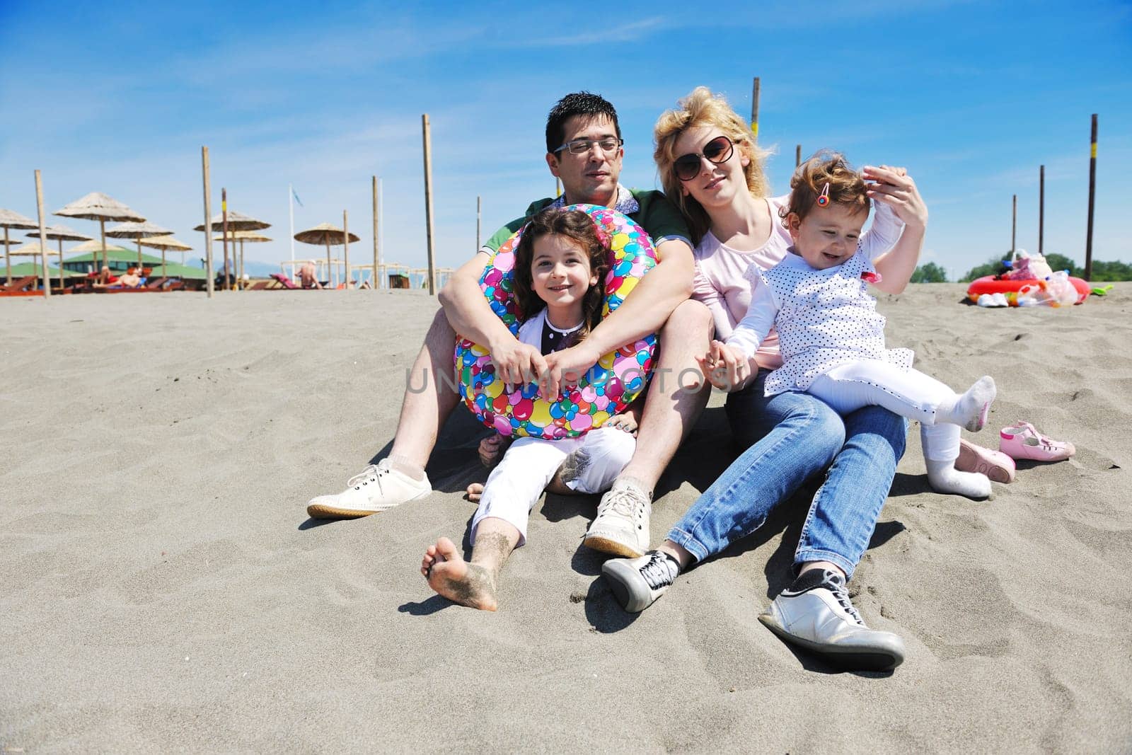 happy young family have fun and live healthy lifestyle on beach