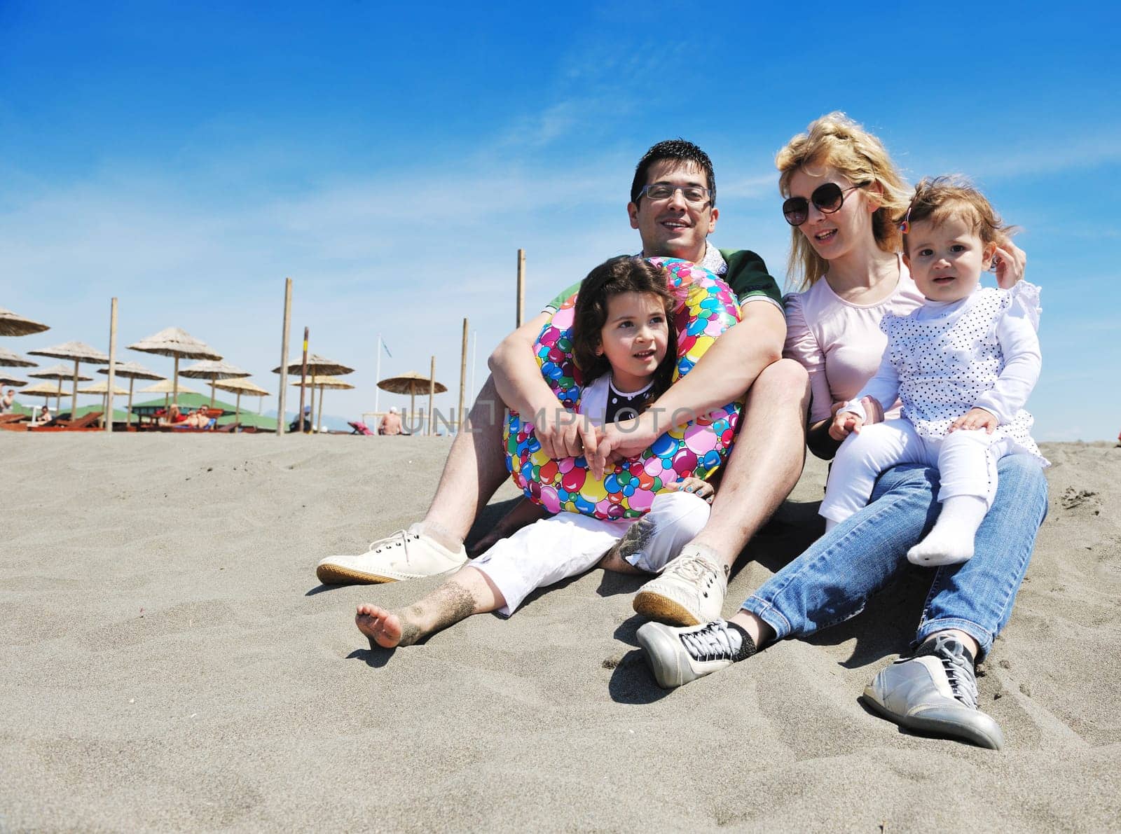 happy young family have fun and live healthy lifestyle on beach