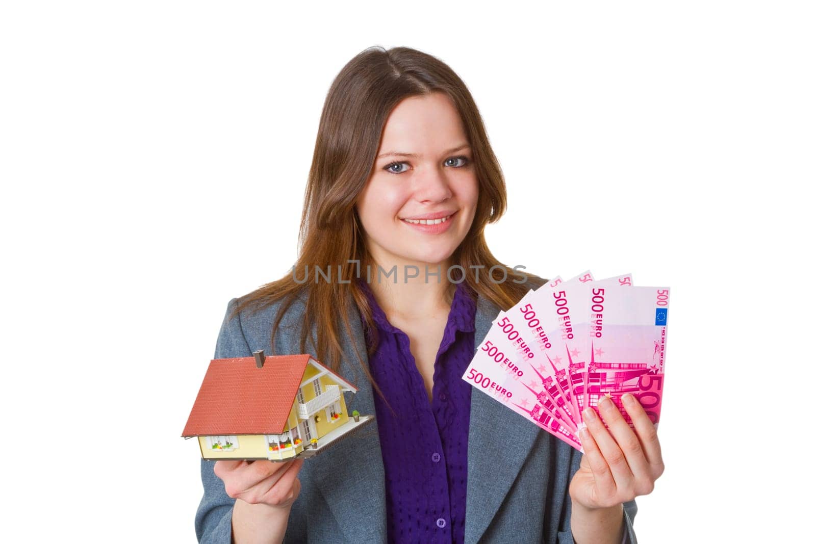 Young attractive real estate agent with model house