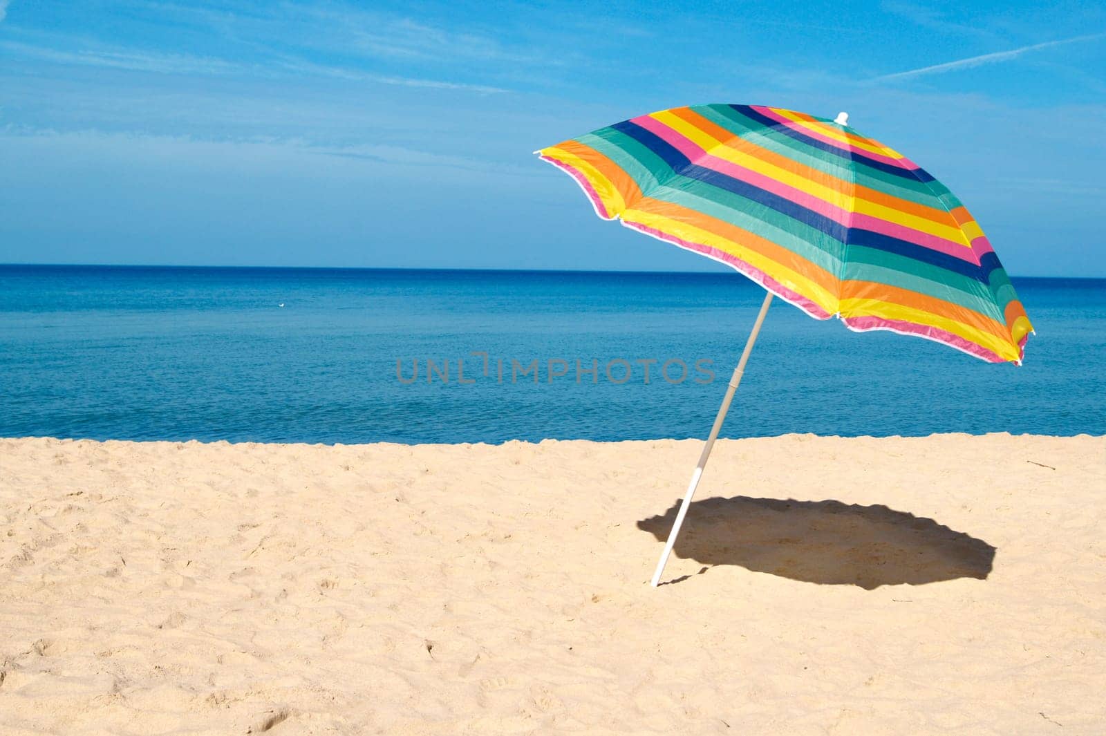 Beach umbrella on a sunny day, sea in background