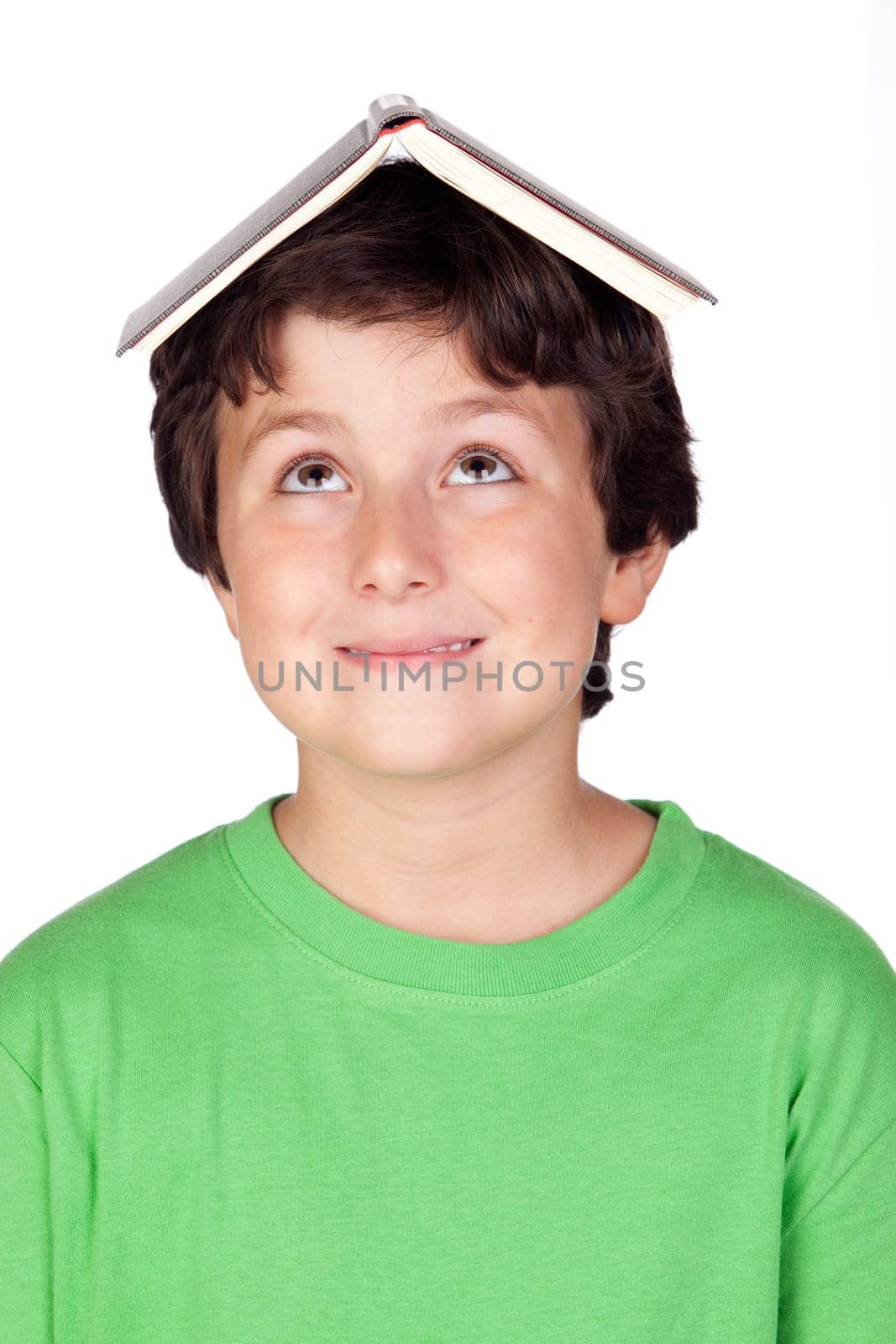 Student child with a book on his head isolated over white background
