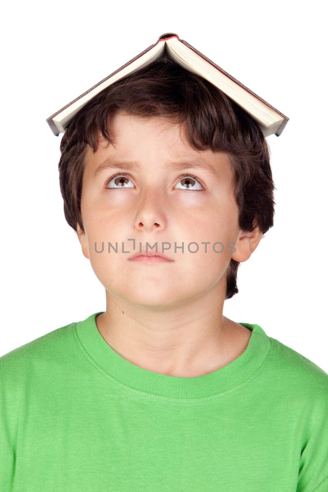 Student child with a book on his head isolated over white background