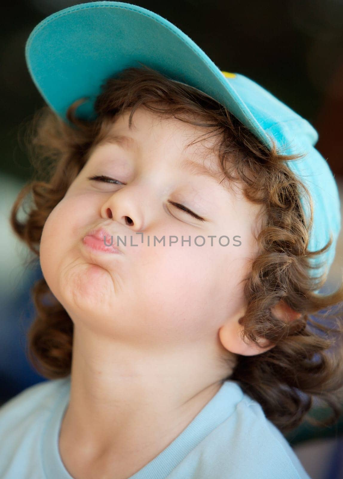 photo of an adorable happy boy making trivialities