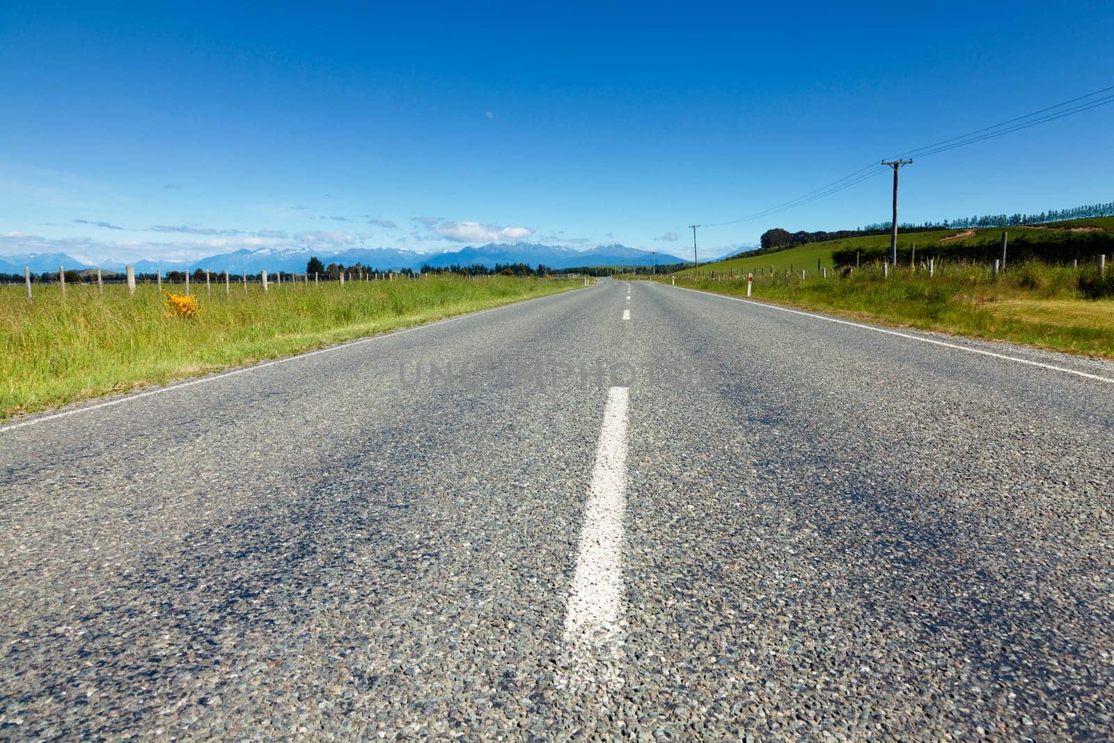 Shot taken in the middle of the road in New Zealand farmland