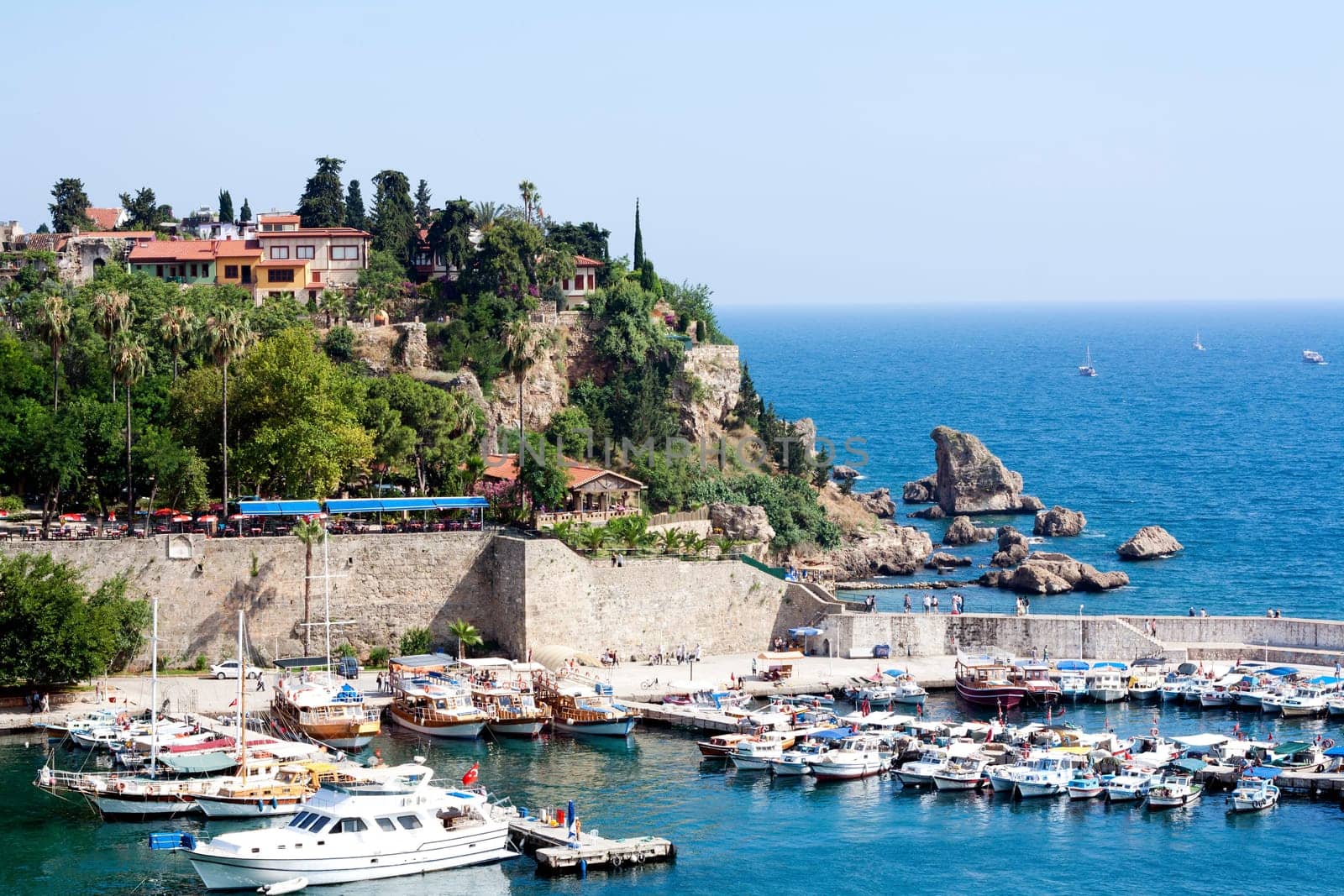 Famous old harbor in Antalya with boats, ships and yachts anchored in it.