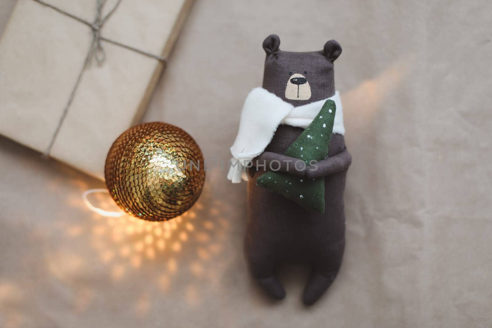 Christmas composition. Toy Teddy Bear, a gift, fir tree branches and decorations. Christmas, winter, new year concept. Flat lay, top view, copy space.