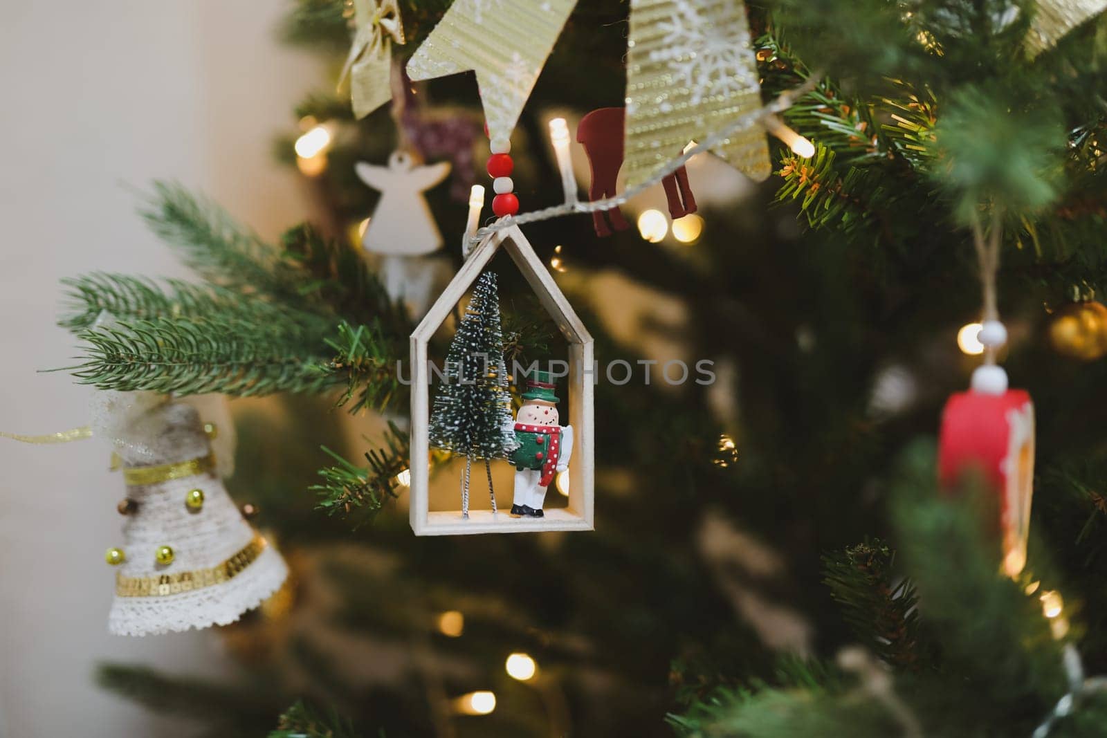 Christmas and New years eve Background. Close up of balls on christmas tree. Bokeh garlands in the background. New Year concept. Decorated Christmas tree on blurred, sparkling and fairy background