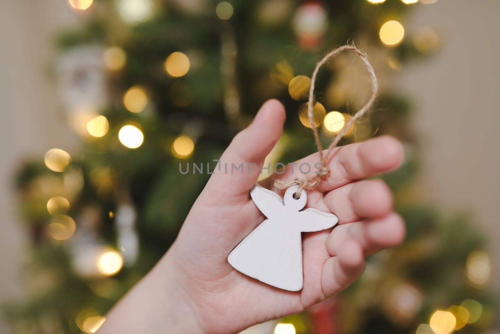 Christmas and New years eve Background. Close up of balls on christmas tree. Bokeh garlands in the background. New Year concept. Decorated Christmas tree on blurred, sparkling and fairy background