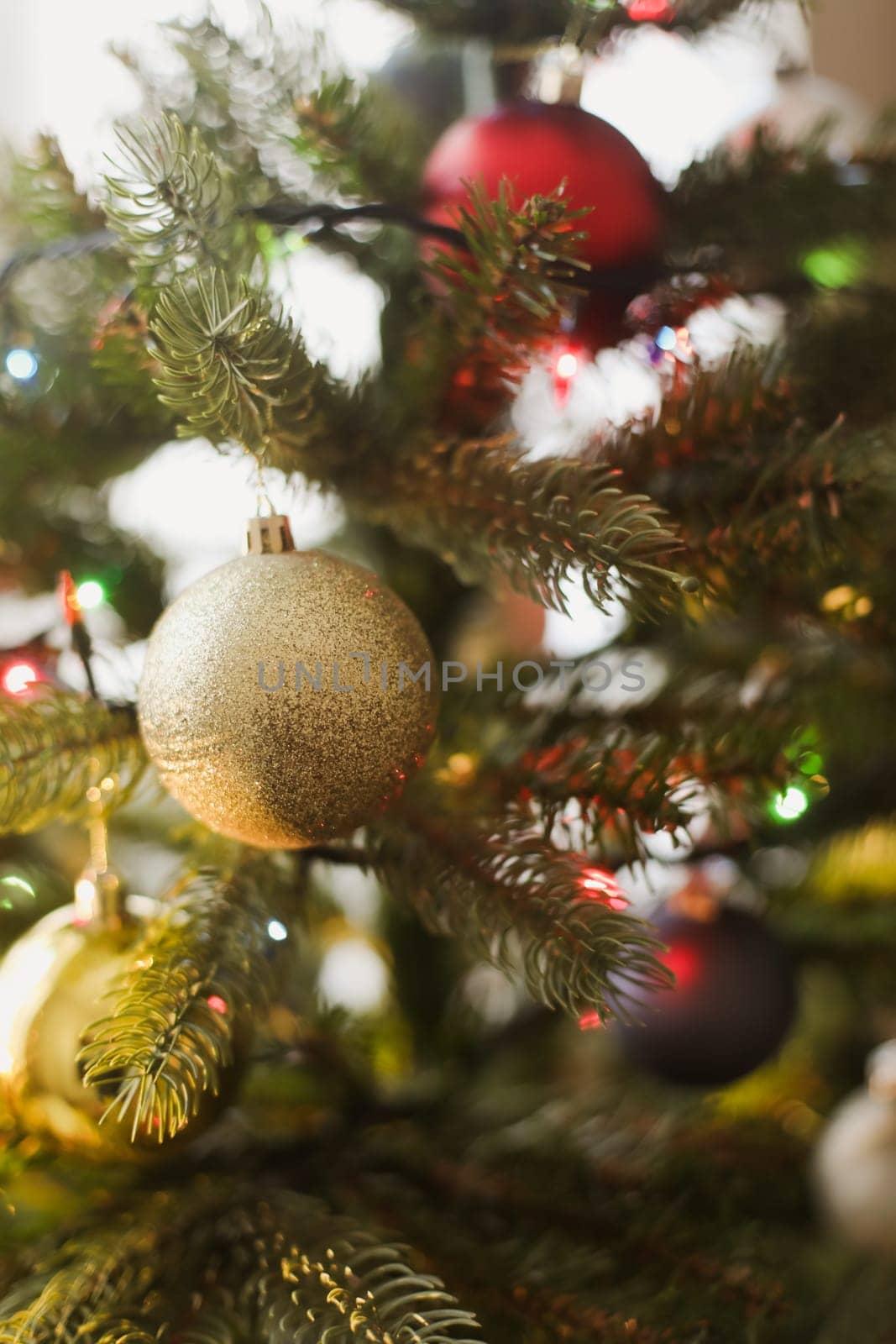 Christmas and New years eve Background. Holiday Template with Christmas toy on fir tree. Web banner with copy space for design. Close up of balls on christmas tree. Bokeh garlands in the background by paralisart