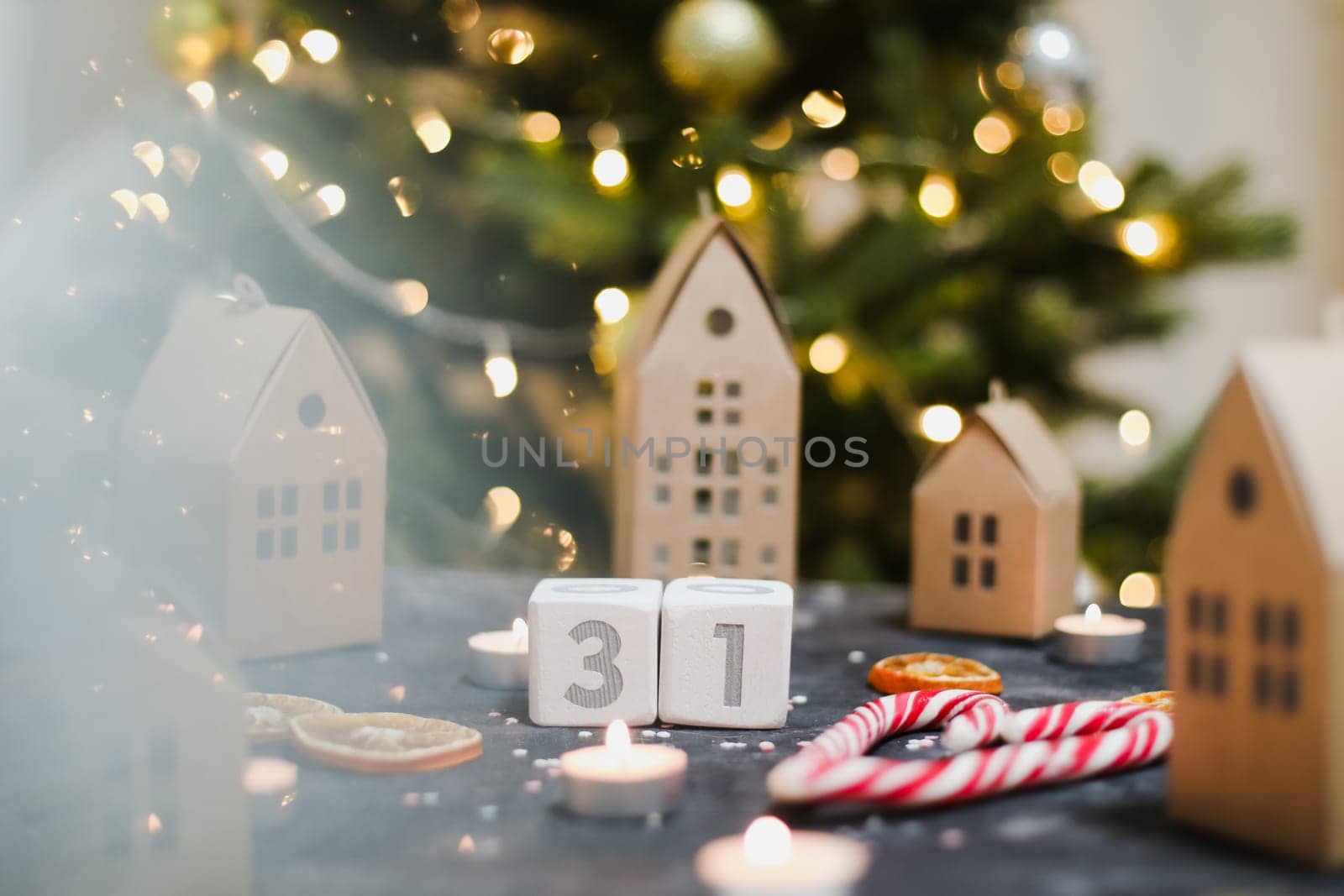 December 31 on white cubes calendar on a background with glowing garland