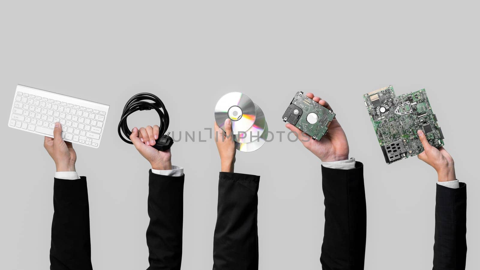 Businessman's hand holding electronic waste on isolated background. Quaint by biancoblue
