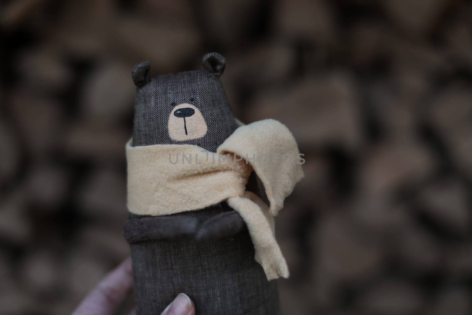 Christmas, New Year, Winter concept. Cozy composition with toy bear on wooden logs under snow.