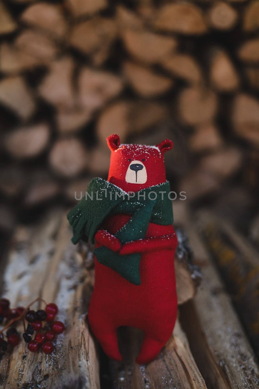 Christmas, New Year, Winter concept. Christmas toy bear on wooden logs by paralisart