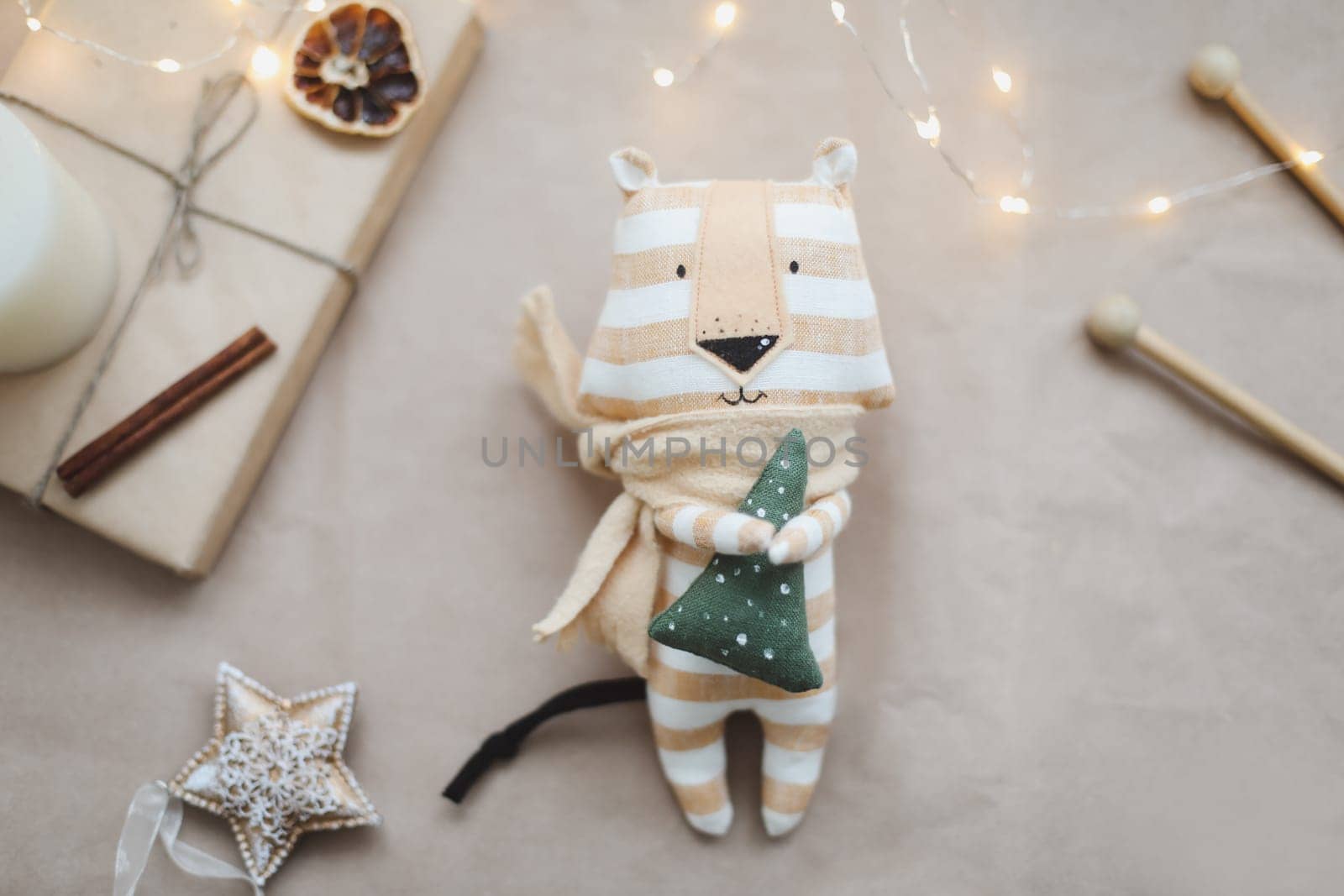 Christmas composition with a tiger toy, symbol of new 2022, a gift, fir tree branches and decorations. Christmas, winter, New year concept. Flat lay, top view.