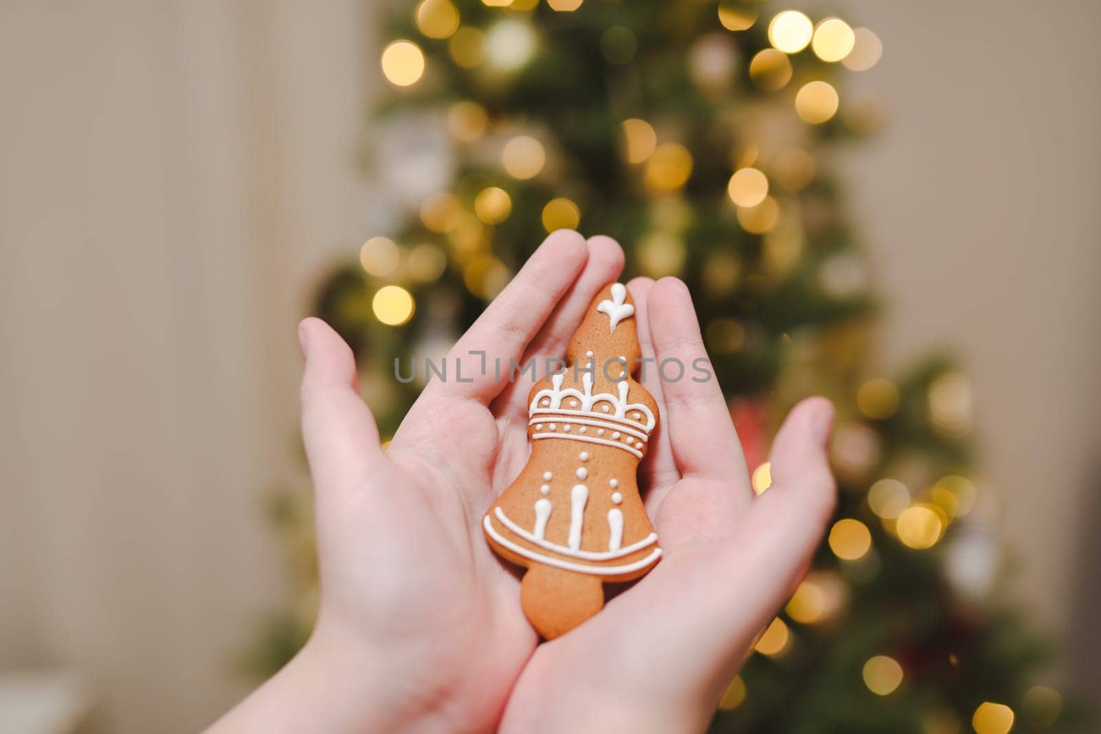 Decorating Christmas tree, holding Christmas toy in a hand. Holiday, Christmas and New Year family celebration concept.