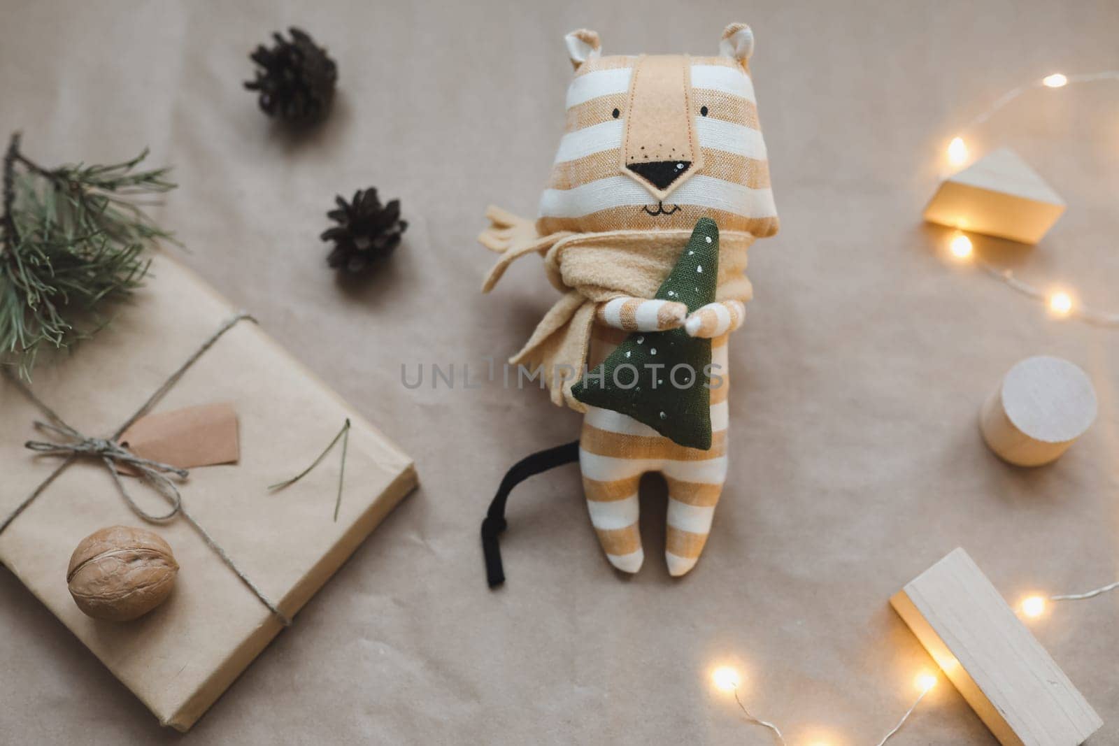 Christmas composition with a tiger toy, symbol of new 2022, a gift, fir tree branches and decorations. Christmas, winter, New year concept. Flat lay, top view.