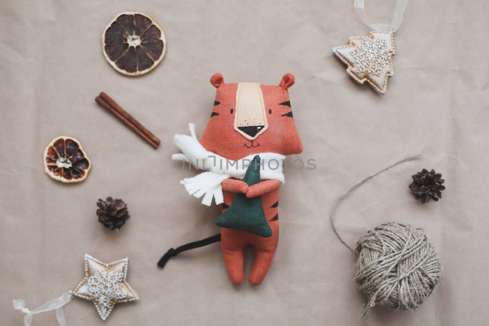 Christmas composition with a tiger toy, symbol of new 2022, a gift, fir tree branches and decorations. Christmas, winter, New year concept. Flat lay, top view.