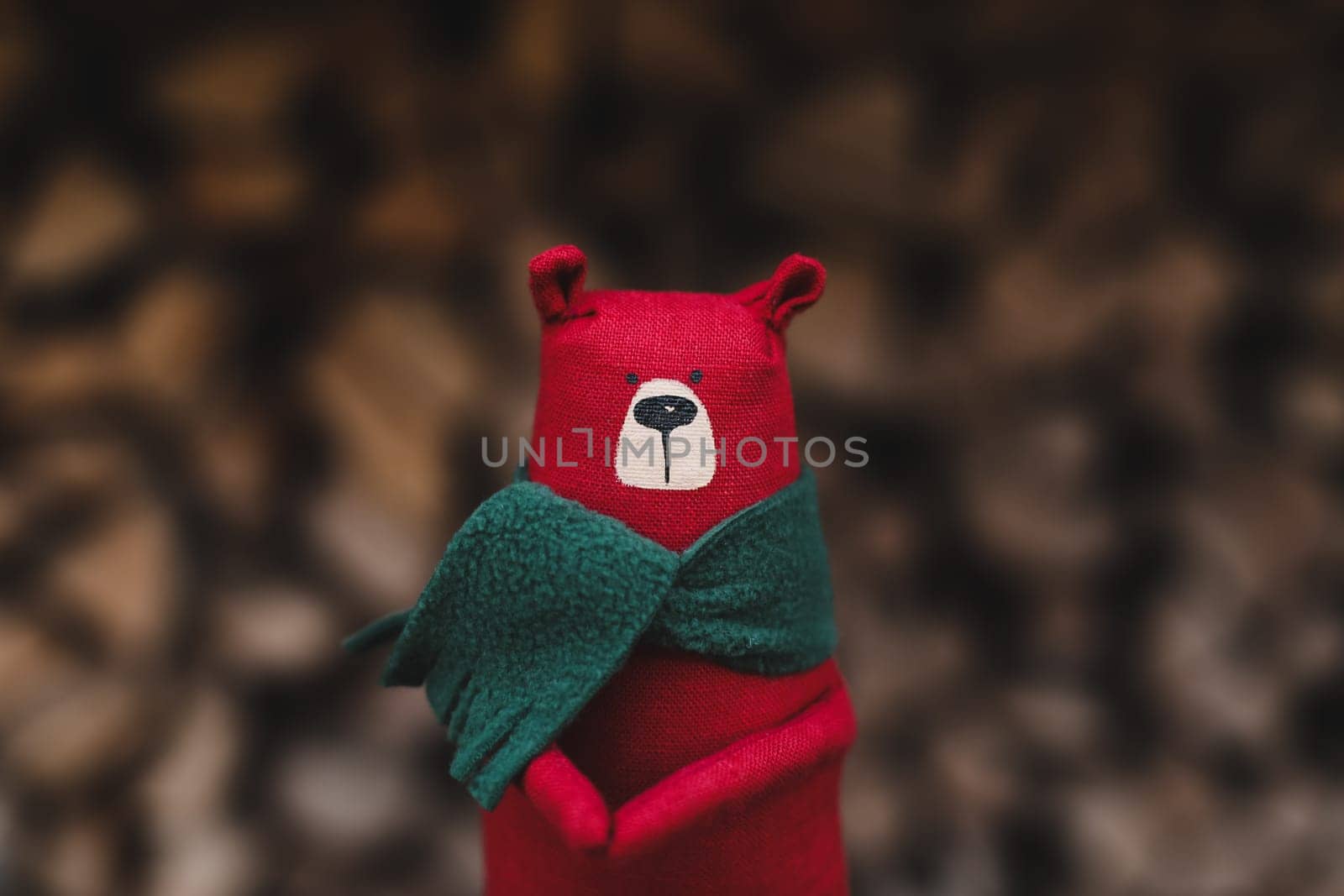 Christmas, New Year, Winter concept. Christmas toy bear on wooden logs by paralisart