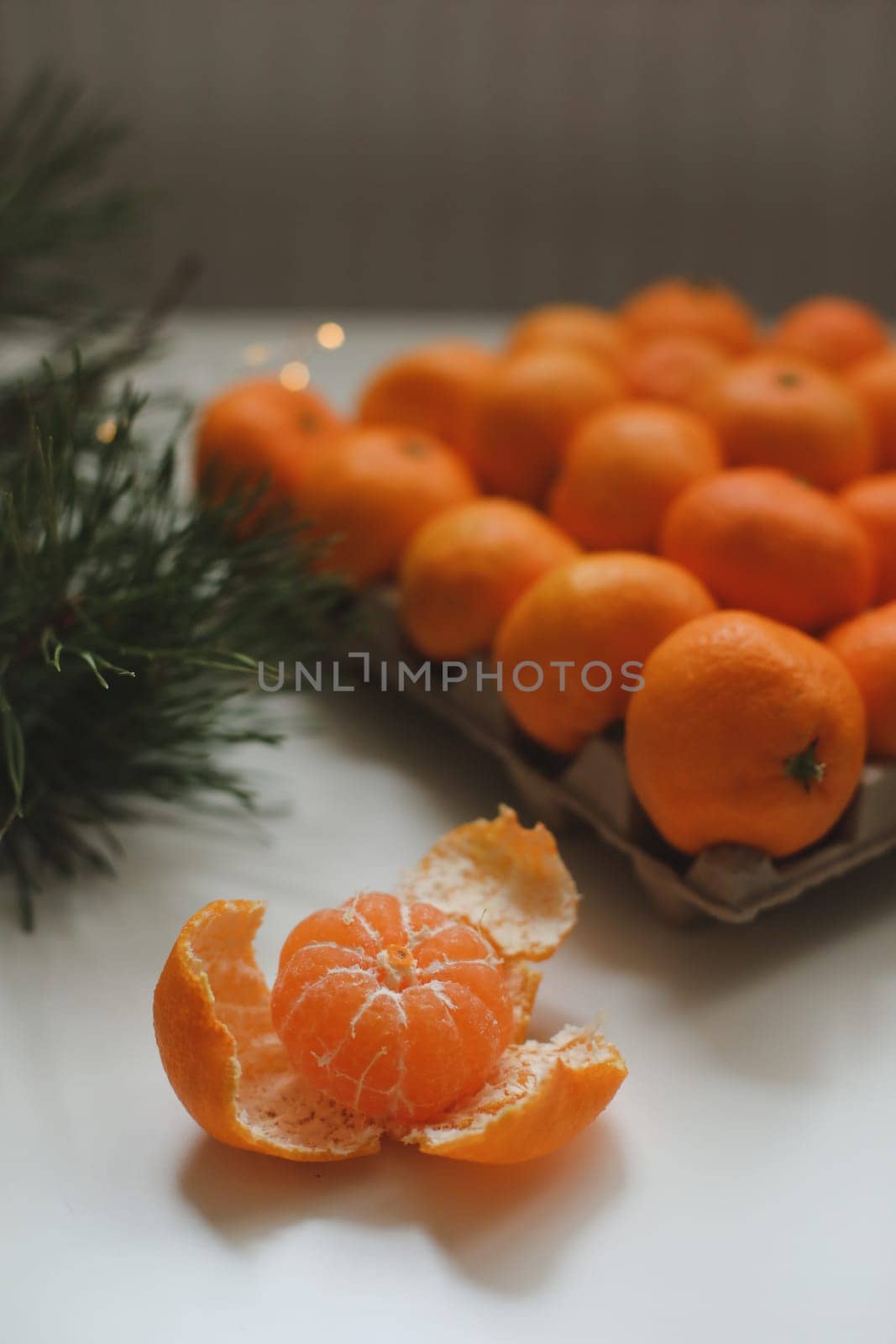 Christmas background with fir tree branches and tangerines. Merry Christmas and Happy New Year Greeting Card. Copy space. Top view. High quality photo