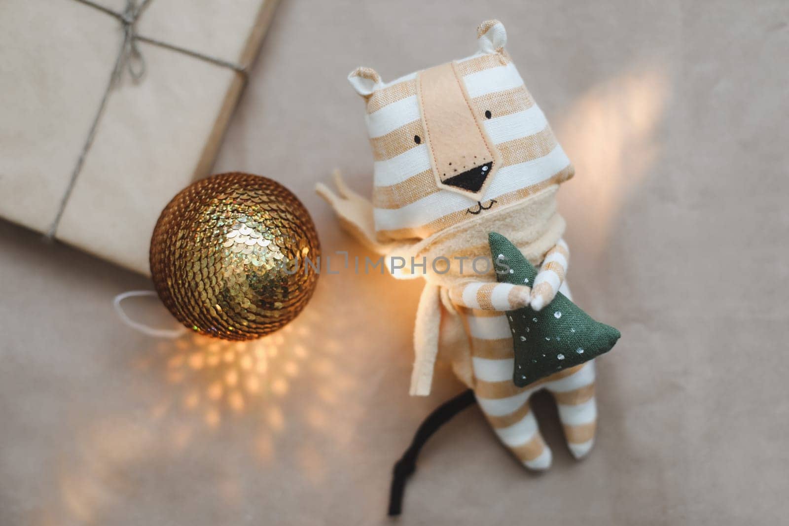 Christmas composition with a tiger toy, symbol of new 2022, a gift and decorations. Christmas, winter, new year concept. Flat lay, top view. High quality photo