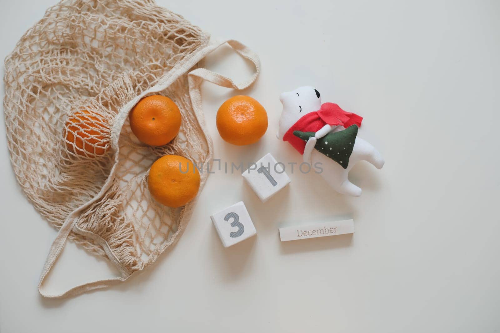 Christmas or New Year composition with tangerines and toy white bear.