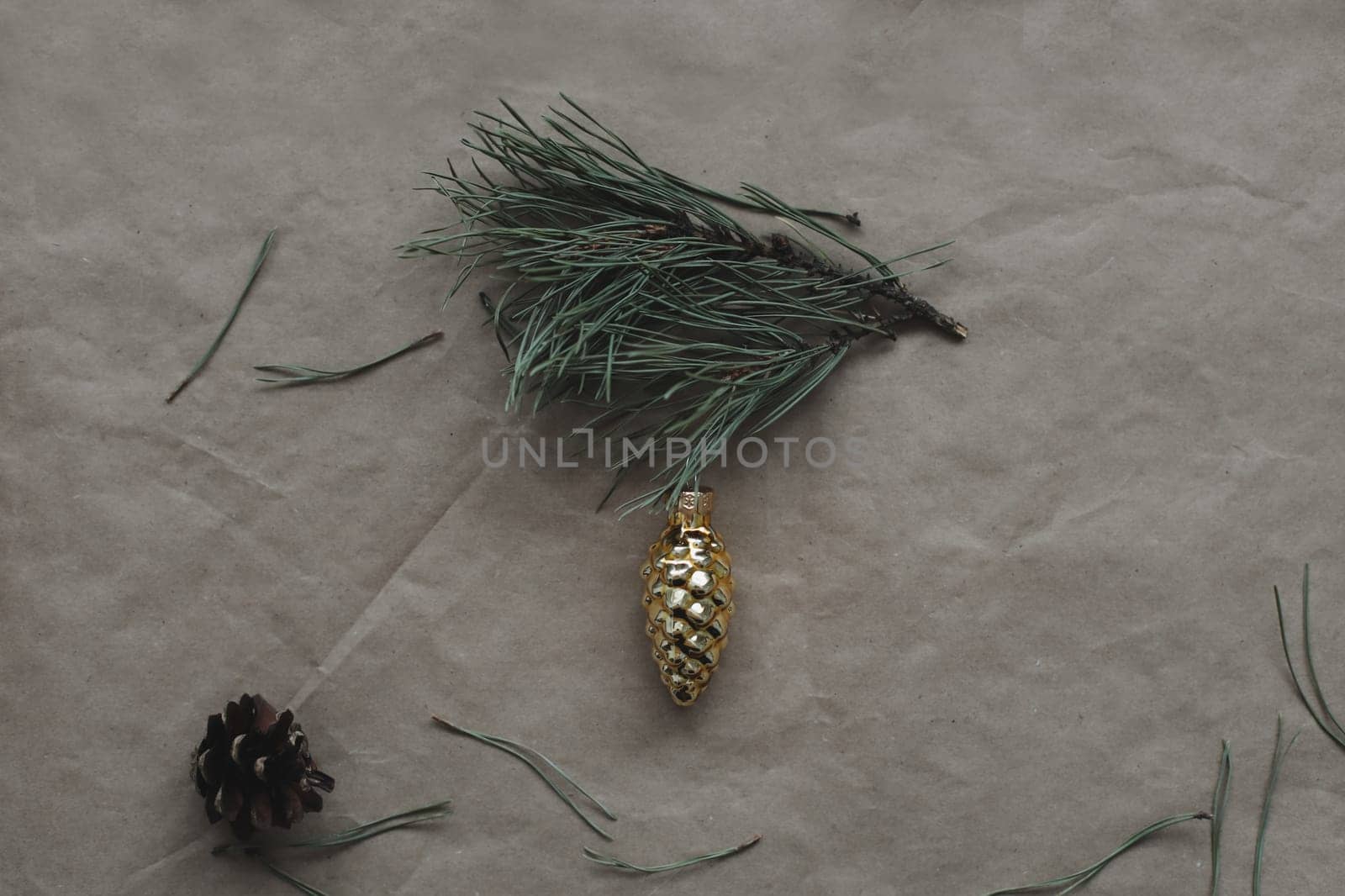 Christmas composition. fir tree branches, balls on craft paper background. Christmas, winter, new year concept. Flat lay, top view, copy space.