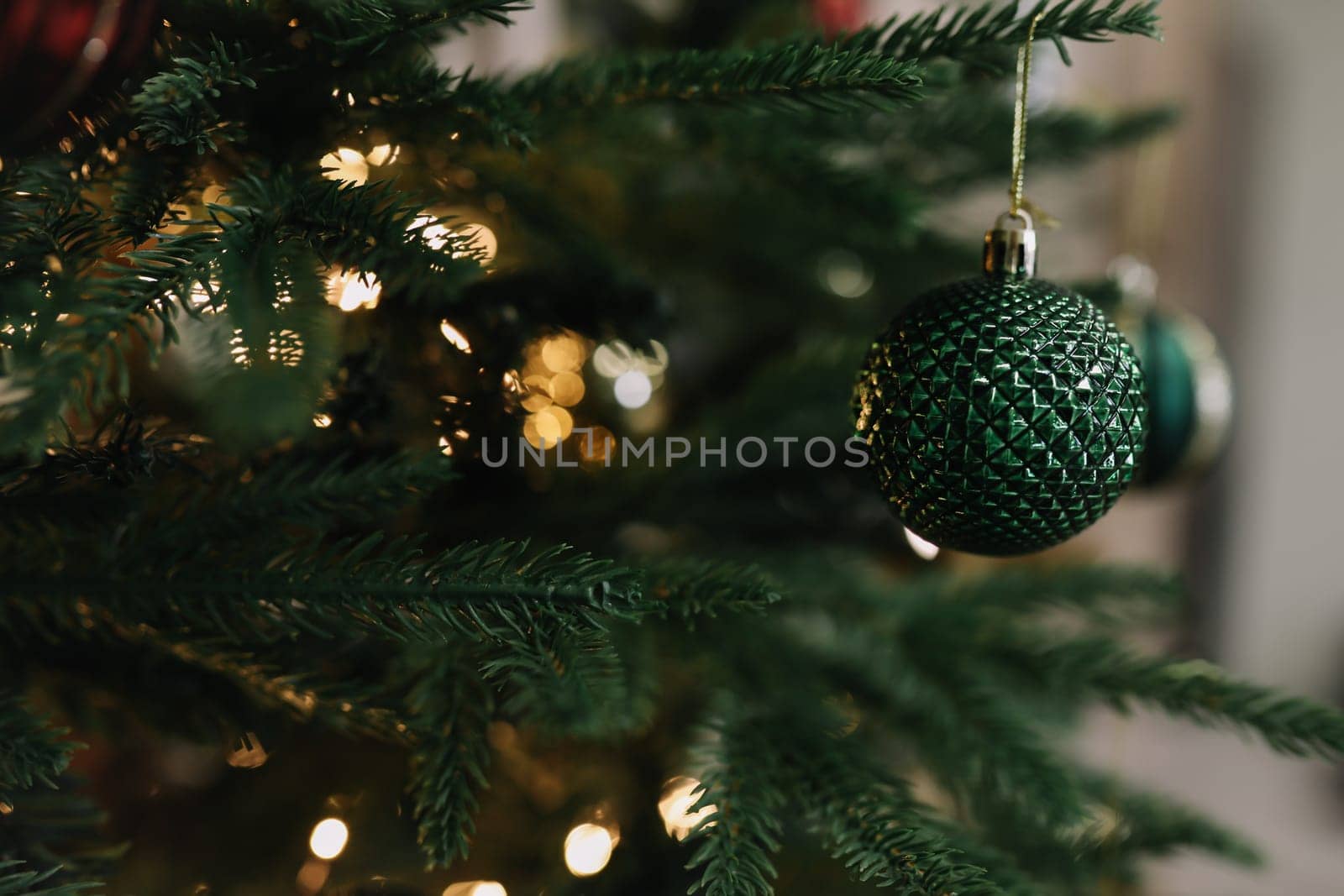 New Year mood 2022. Beautiful Christmas tree with balls and decorations. Sparkling Christmas ornament. Christmas and New Year background