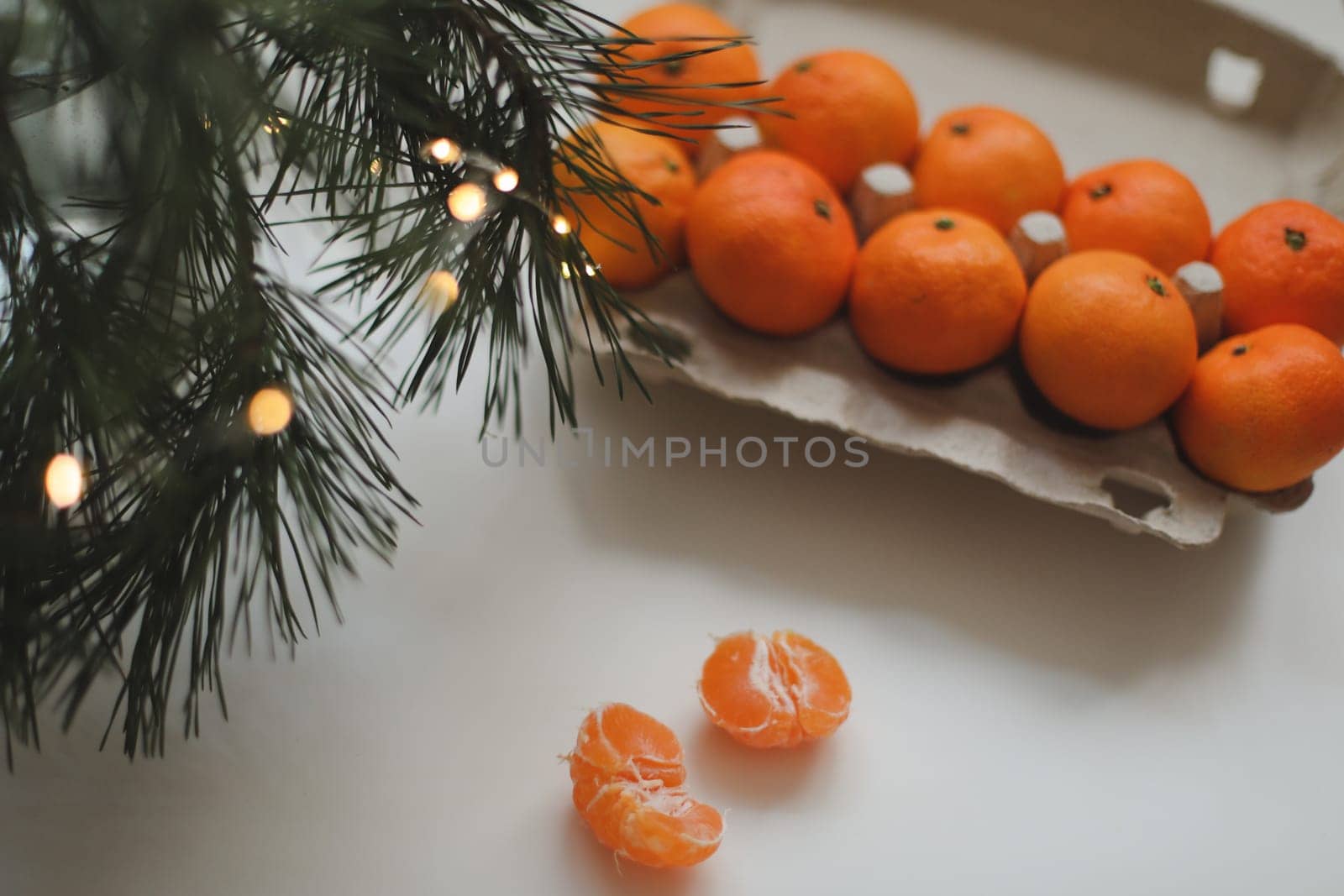 Christmas background with fir tree branches and tangerines. Merry Christmas and Happy New Year Greeting Card. Copy space. Top view. High quality photo