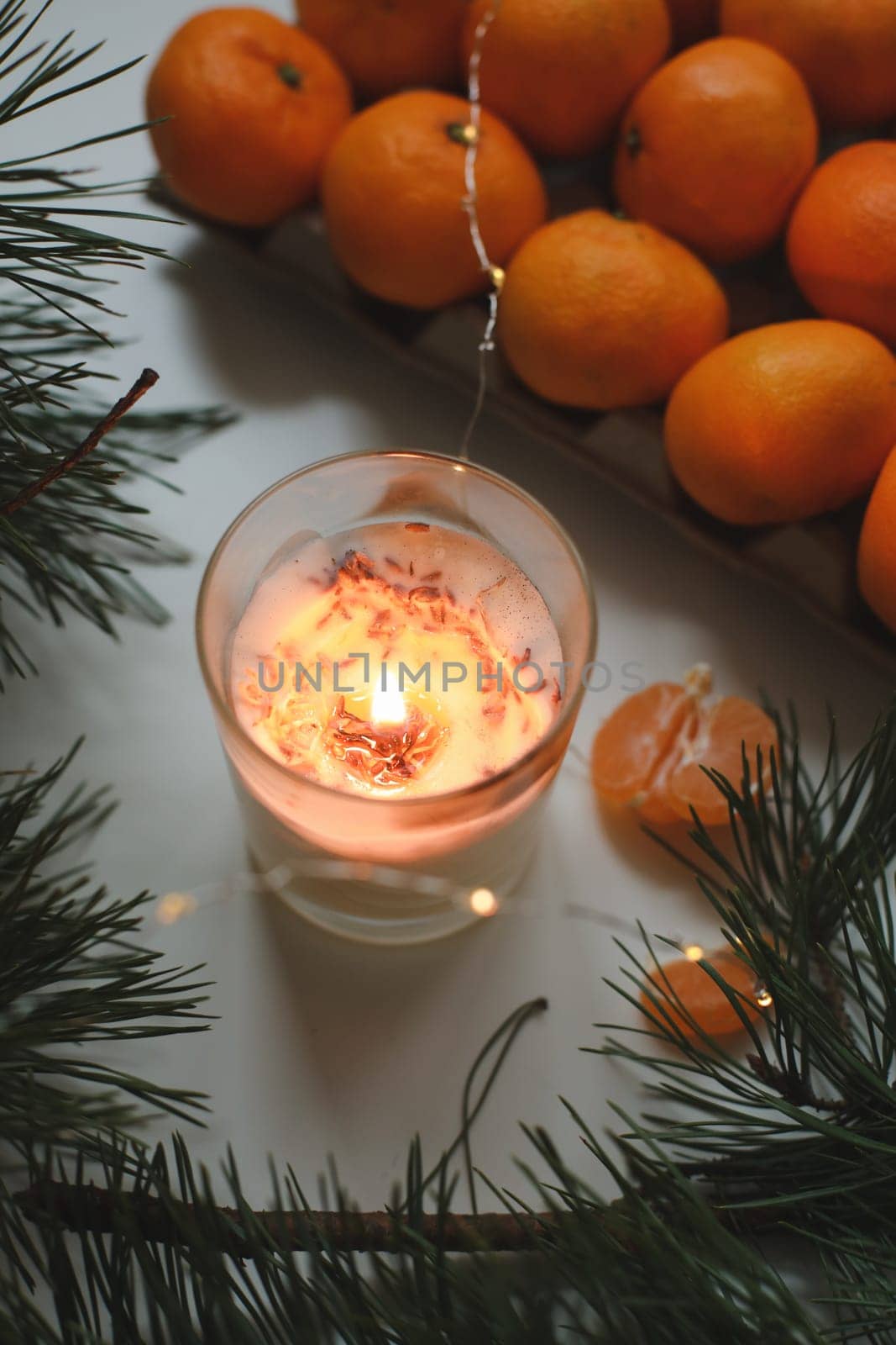 Christmas background with fir tree branches and tangerines. Merry Christmas and Happy New Year Greeting Card. Copy space. Top view. High quality photo