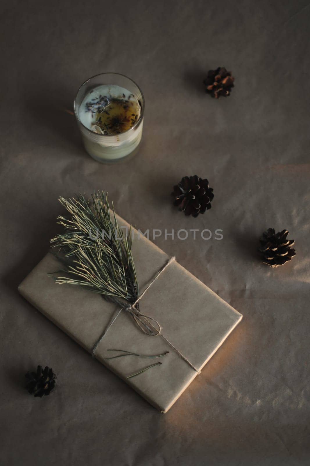 Christmas composition. Gift, fir tree branches, balls and decorations on paper background. Christmas, winter, new year concept. Flat lay, top view, copy space by paralisart