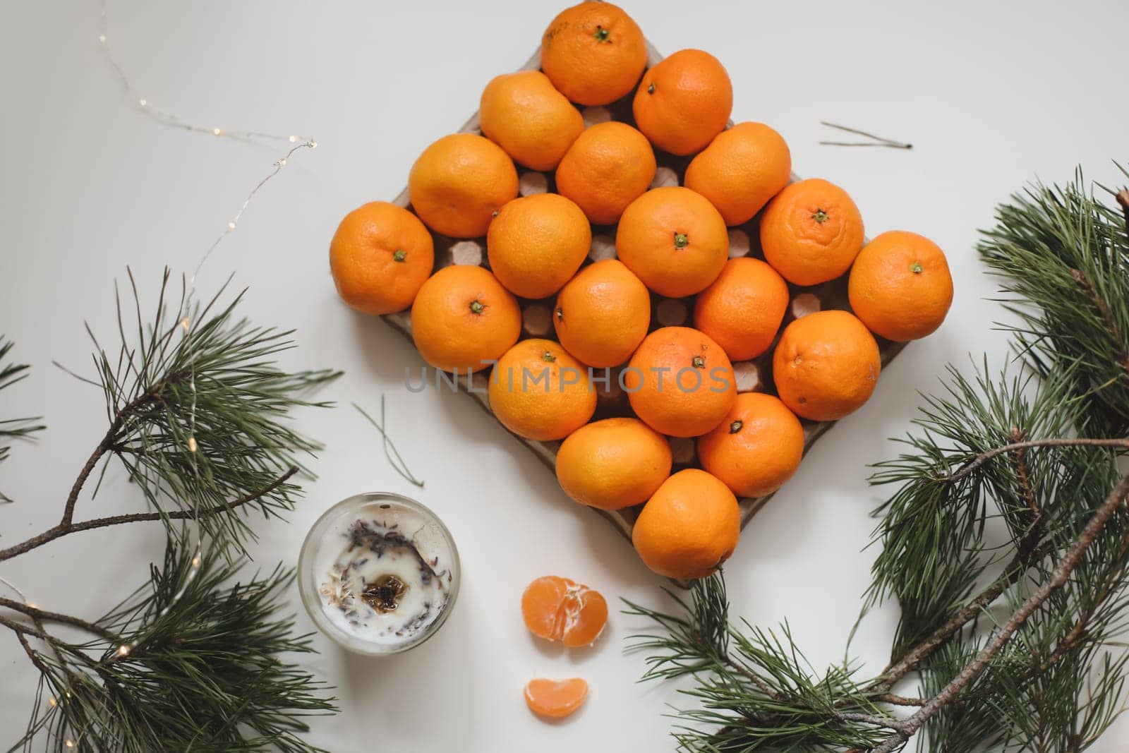 Christmas background with fir tree branches and tangerines. Merry Christmas and Happy New Year Greeting Card. Copy space. Top view. High quality photo