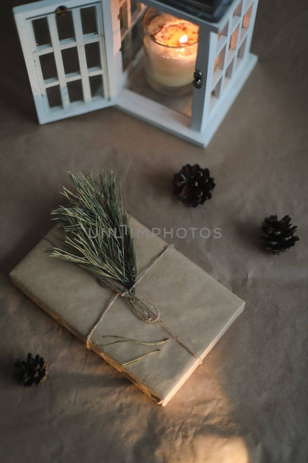 Christmas composition. Gift, fir tree branches, balls on paper background. Christmas, winter, new year concept. Flat lay, top view, copy space by paralisart