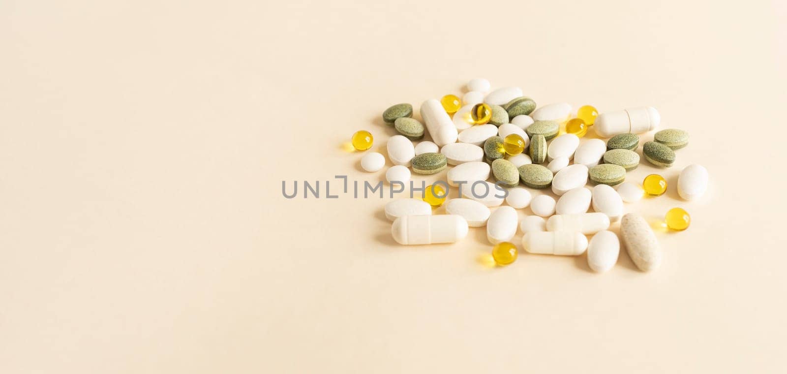 Banner Colorful Pile of Scattered Capsules, Pills, Tablets on Beige Background. Various Medical Supplements, Vitamins or Drug Pharmaceutical Concept. Copy Space For Text. Health Insurance, Horizontal