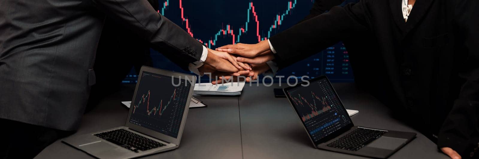 Stock investor put hand stack together over table as synergy. Trailblazing by biancoblue