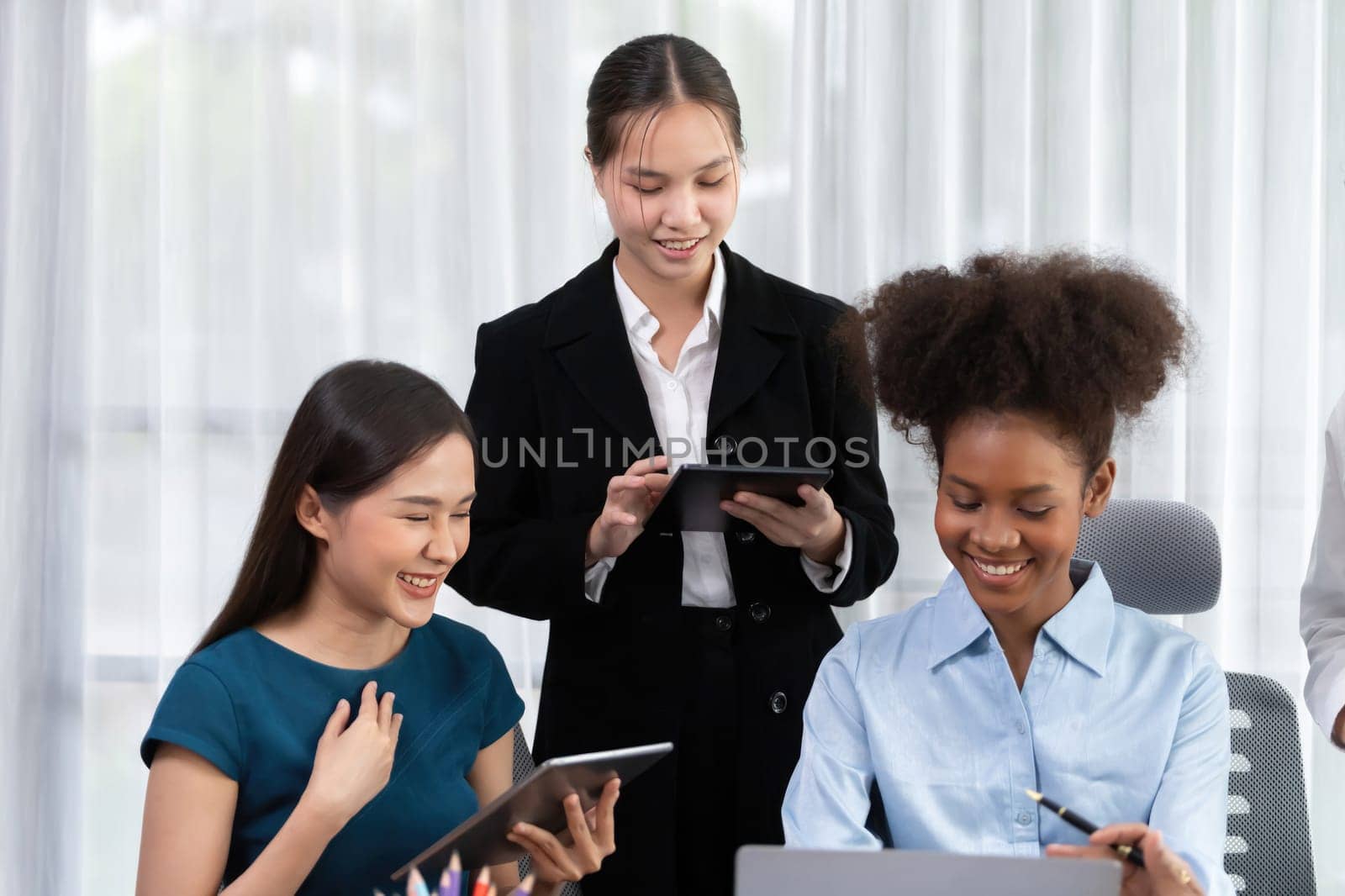 Happy diverse business people work together, discussing in corporate office. Professional and diversity teamwork discuss business plan on desk with laptop. Modern multicultural office worker. Concord