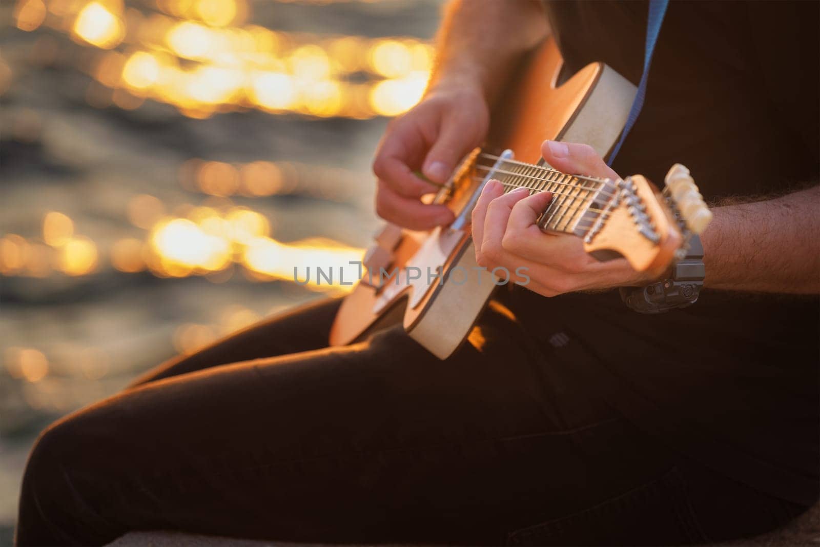 Street musician playing electric guitar hands close up by dimol