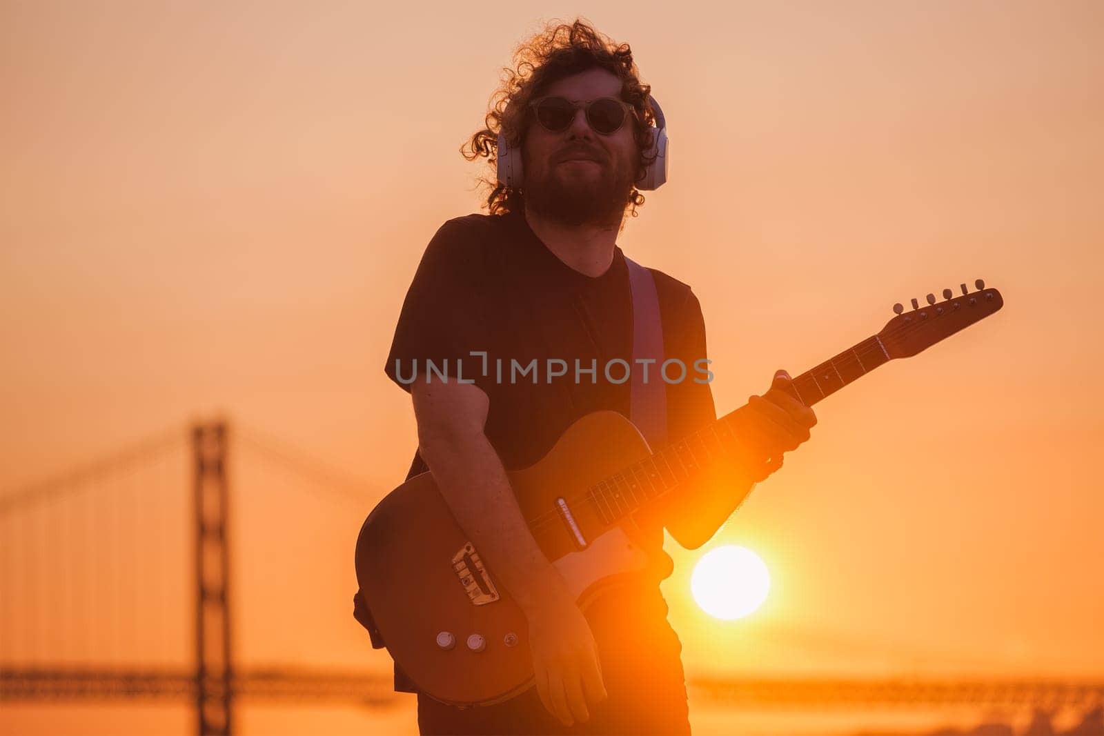 Street musician playing electric guitar in the street by dimol