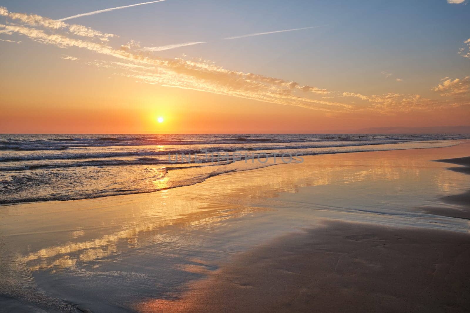 Atlantic ocean sunset with surging waves at Fonte da Telha beach, Costa da Caparica, Portugal