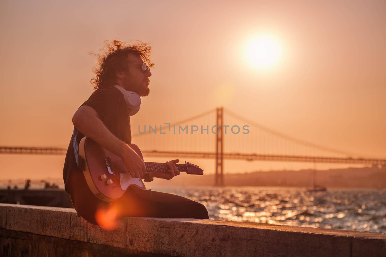 Street musician playing electric guitar in the street by dimol