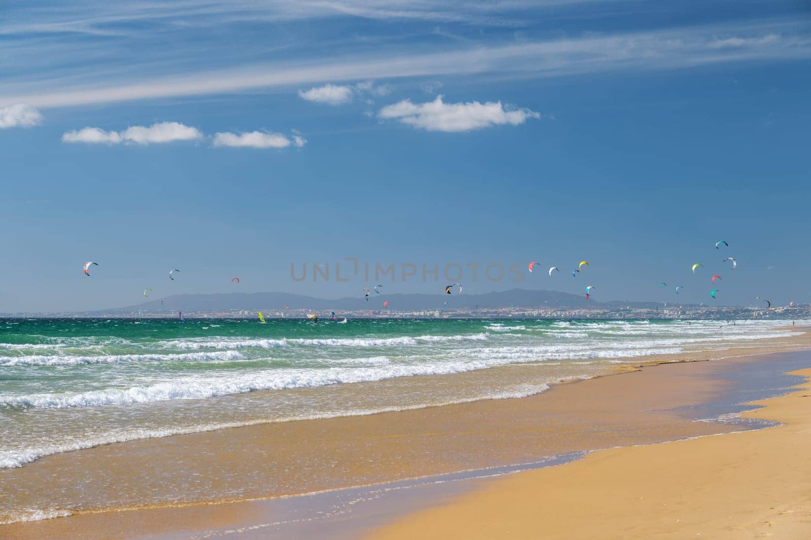 Kiteboarding kitesurfing kiteboarder kitesurfer kites on the ocean beach by dimol