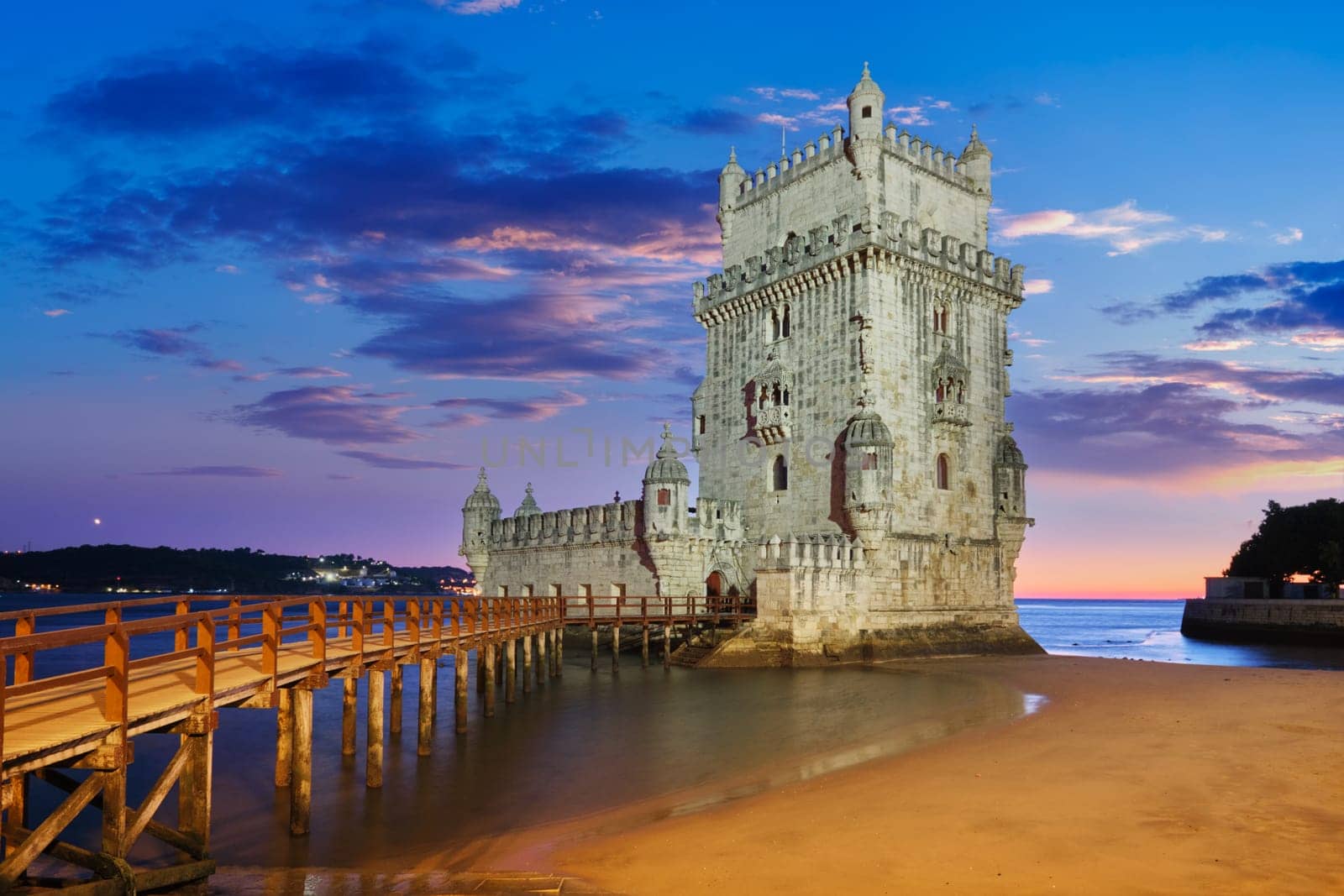 Belem Tower on the bank of the Tagus River in twilight. Lisbon, Portugal by dimol