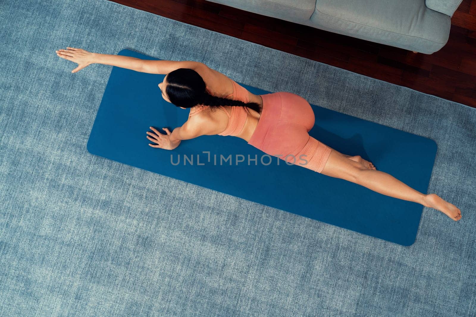 Top view asian woman in sportswear doing yoga exercise. Vigorous by biancoblue