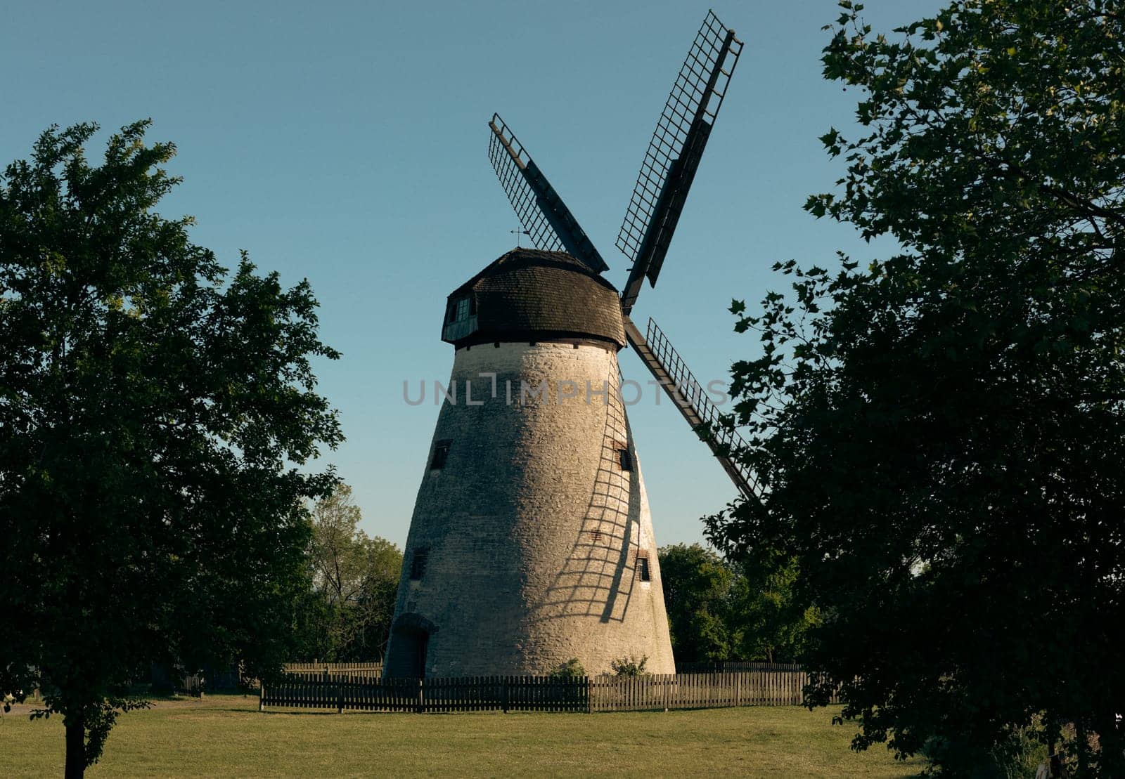 Beautiful view of an old abandoned windmill in a city park in Germany, close-up side view.