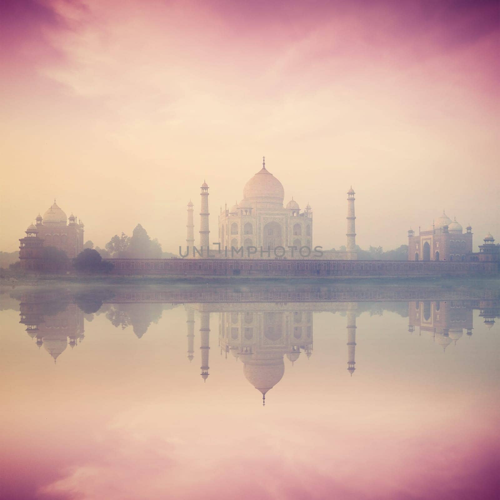 Vintage retro hipster style image of Taj Mahal on sunrise sunset reflection in Yamuna river panorama in fog, Indian Symbol - India travel background. Agra, Uttar Pradesh, India